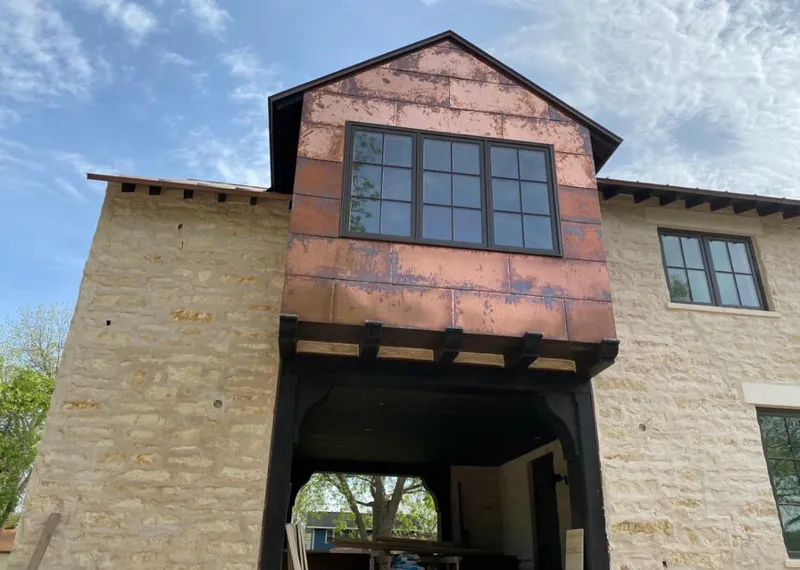 Copper metal panel facade on a stone building for Skylight Installation in Fort Mill
